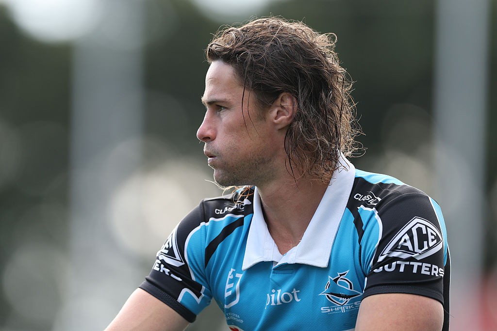 NRL players contesting possession under lights late in the season